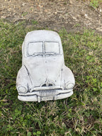 22nice4me Garden Statues 1955 FJ Ute concrete garden ornament with an antique finish sitting on green grass