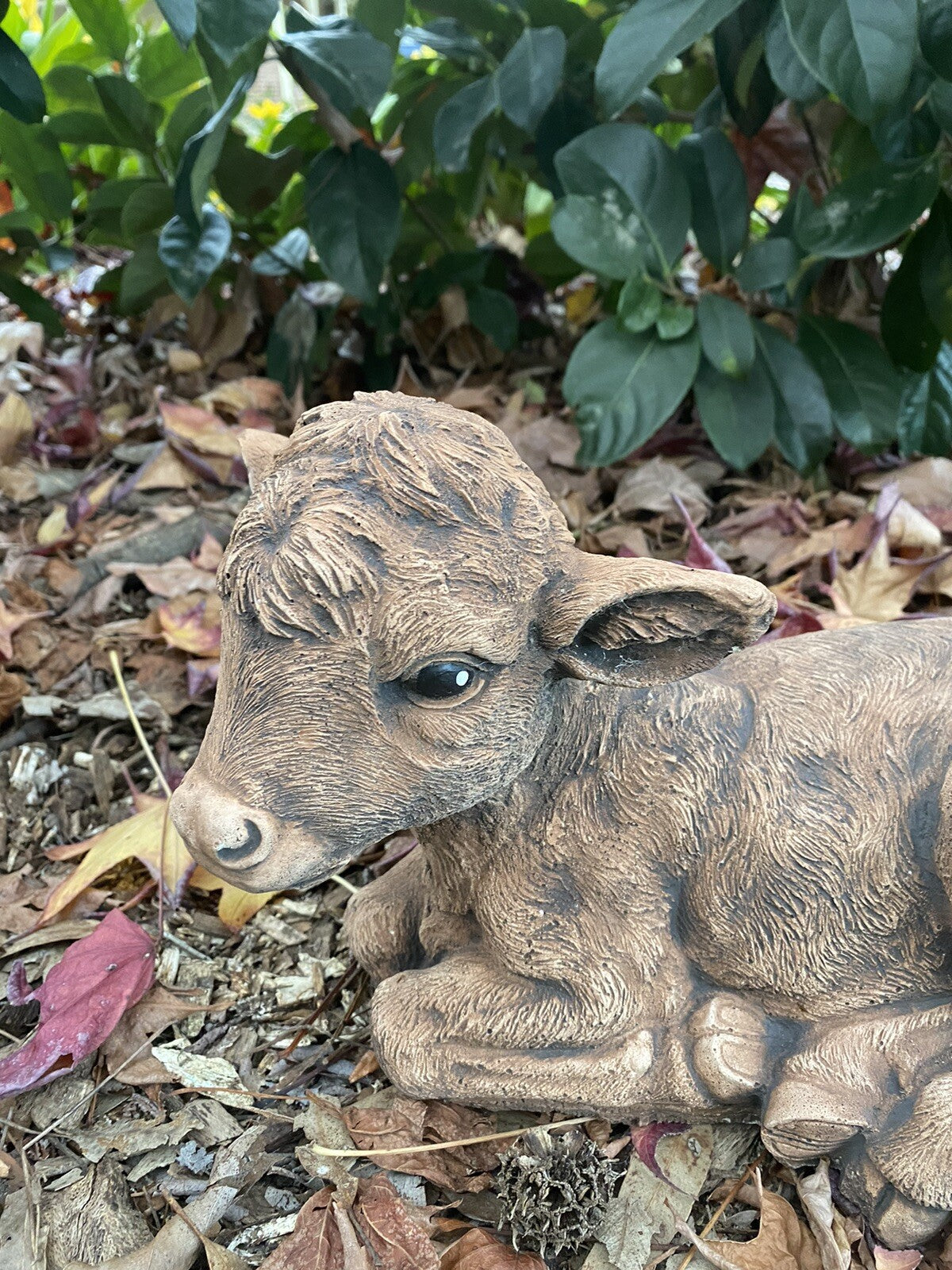 22nice4me Garden Statues brown concrete calf ornament laying down in a garden setting with a realistic matte finish