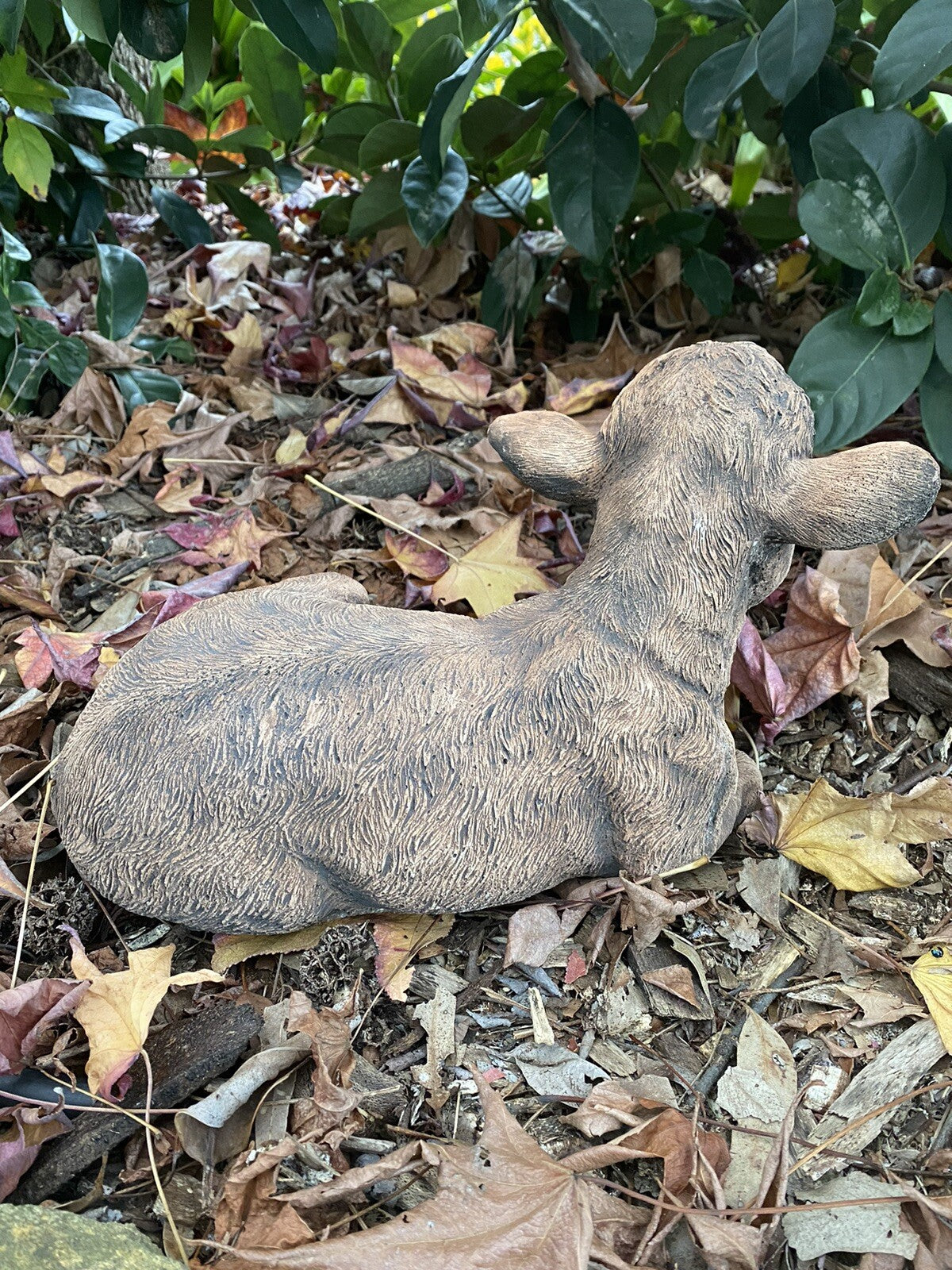 22nice4me Garden Statues brown concrete calf statue laying down in a garden setting with autumn leaves