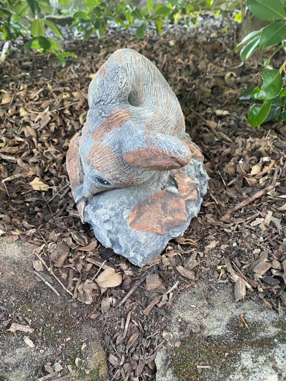 22nice4me Garden Statues hand-painted concrete bilby ornament with an antique finish resting on a rock in a garden