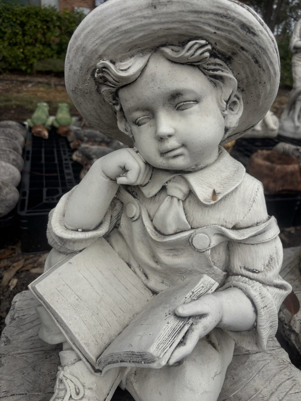 22nice4me Garden Statues concrete boy statue wearing a hat and reading a book while sitting on a rustic bench