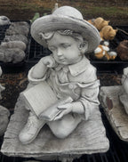 22nice4me Garden Statues concrete boy reading a book on a rustic bench, featuring detailed clothing and hat.