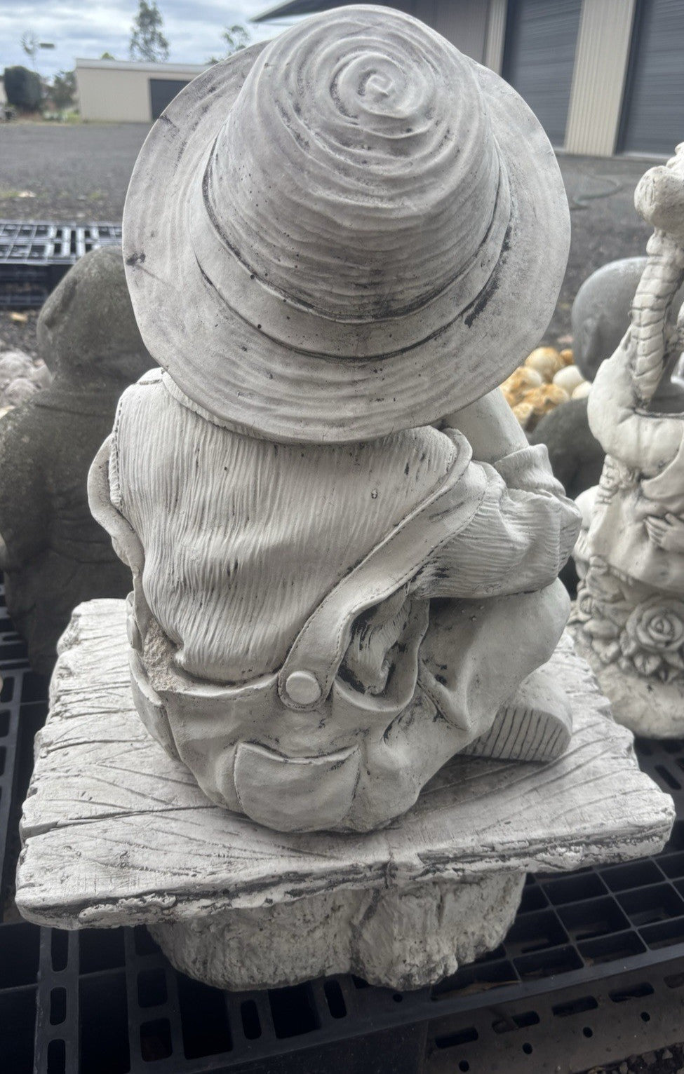 22nice4me Garden Statues concrete boy statue wearing a hat and overalls sitting on a rustic bench, back view