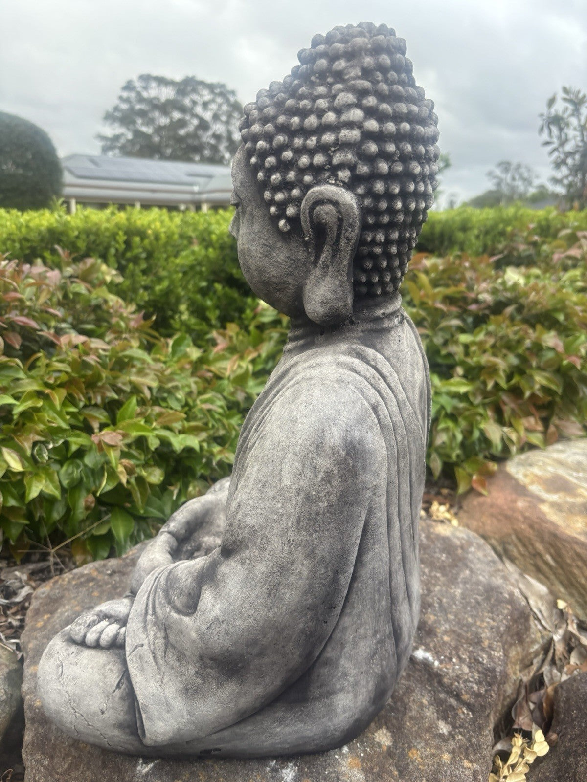 22nice4me Garden Statues concrete Buddha in meditation pose with weathered grey finish, side view in a garden setting.