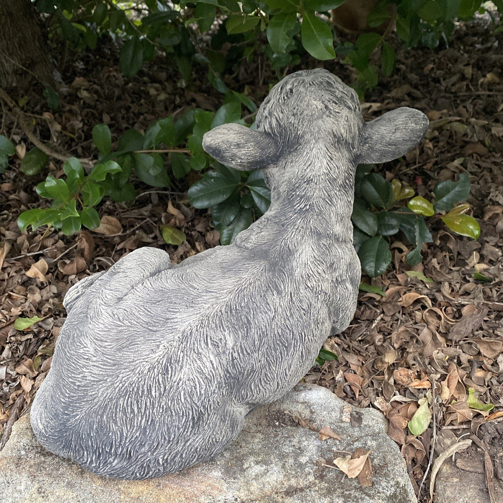 22nice4me Garden Statues hand-painted concrete calf statue laying down in a garden setting
