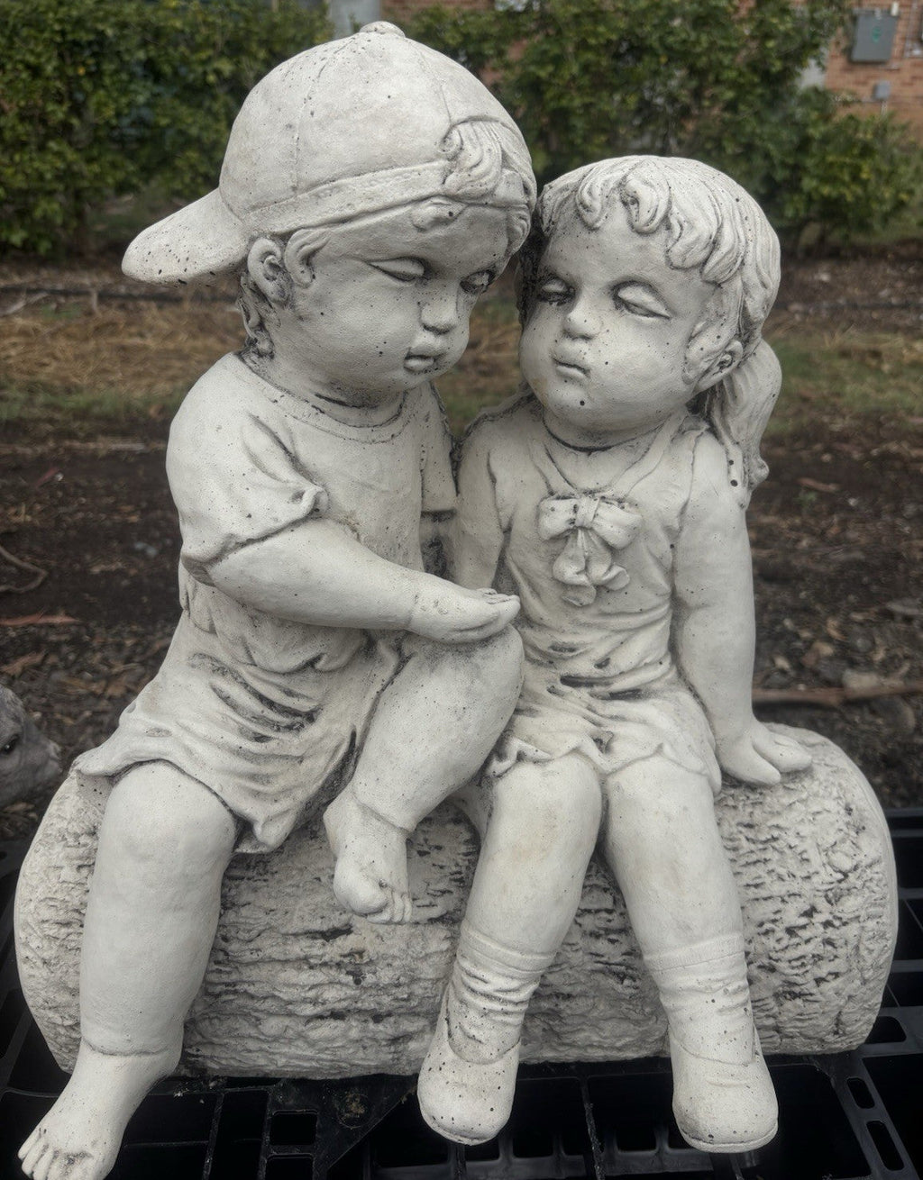 22nice4me Garden Statues concrete boy and girl sitting on a log ornament with a natural stone finish