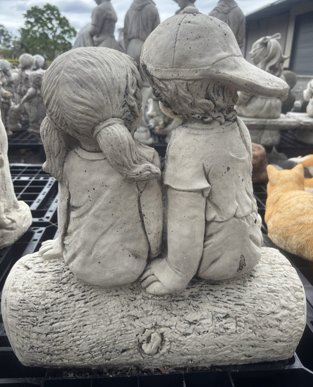 22nice4me Garden Statues concrete boy and girl sitting on a log ornament with a natural stone finish