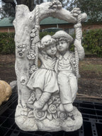 22nice4me Garden Statues concrete boy and girl on a floral swing garden ornament with vintage tree arch design