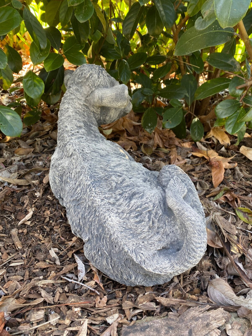 22nice4me Garden Statues concrete cow calf ornament in a grey matt finish, resting in a garden setting.