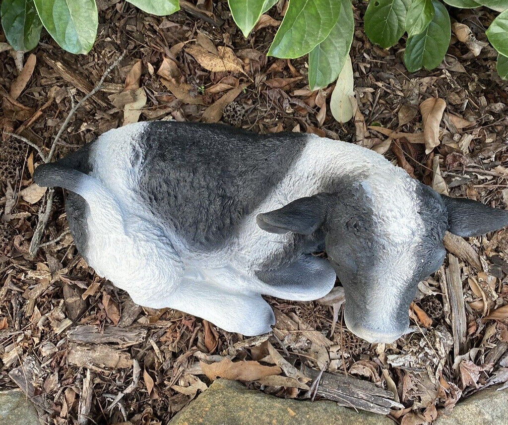 22nice4me Garden Statues hand-painted concrete Holstein Friesian cow ornament resting in a garden setting
