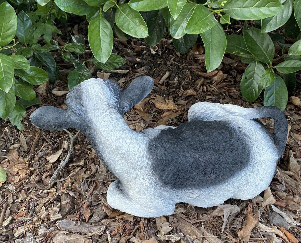 22nice4me Garden Statues hand-painted concrete Holstein Friesian cow ornament resting in a garden setting