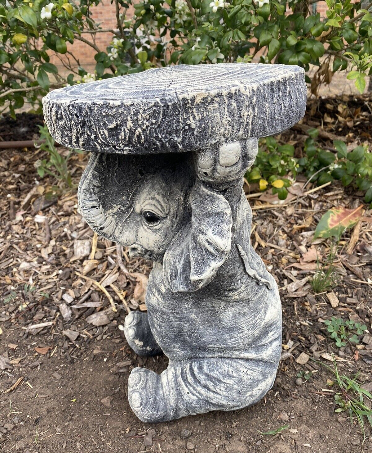 22nice4me Garden Statues elephant concrete pot plant stand with a textured tree stump top in a garden setting