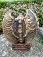 22nice4me Garden Statues concrete gargoyle with large curved wings and a rustic finish in a garden setting