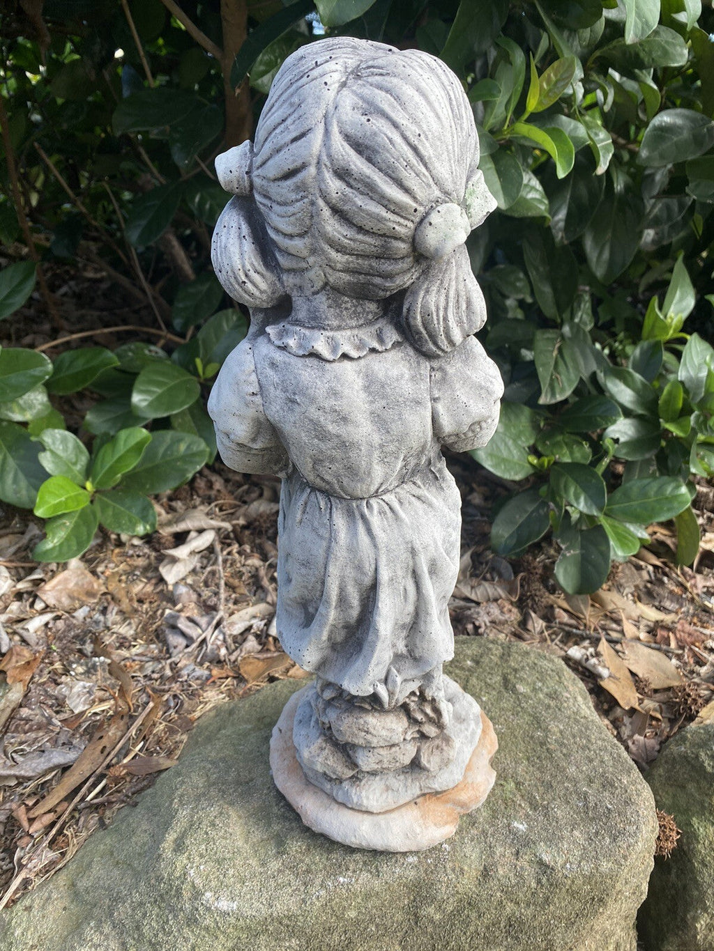 22nice4me Garden Statues concrete girl ornament with pigtails standing on a rock in a garden setting