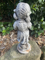 22nice4me Garden Statues concrete girl ornament with pigtails standing on a rock in a garden setting