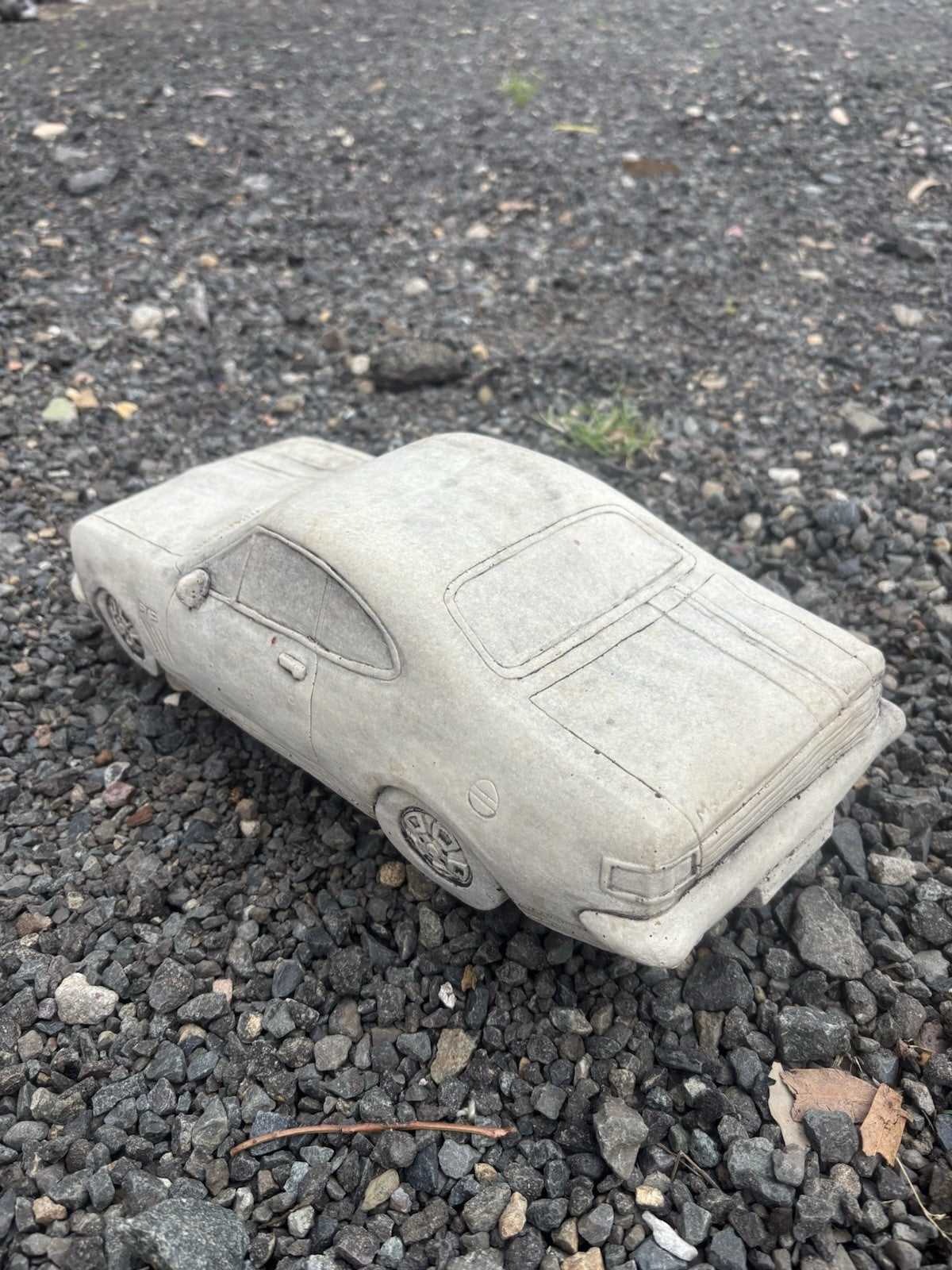 22nice4me Garden Statues concrete HK Monaro muscle car ornament with detailed bodywork on a gravel surface