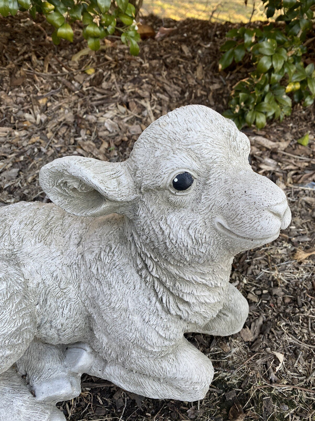 22nice4me Garden Statues concrete lamb ornament with a textured matt finish, laying down in a garden setting.