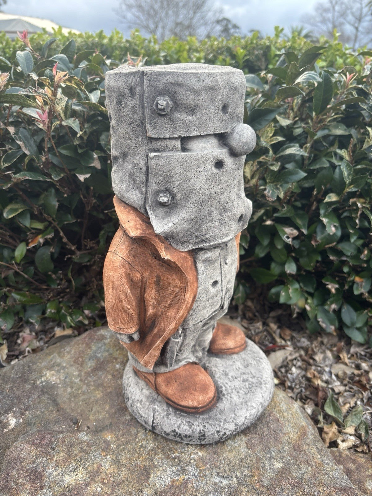 22nice4me Garden Statues concrete Ned Kelly figure with grey armour and brown coat standing on a stone base