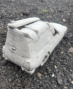 22nice4me Garden Statues concrete Sandman panel van ornament with a roof surfboard on a gravel surface
