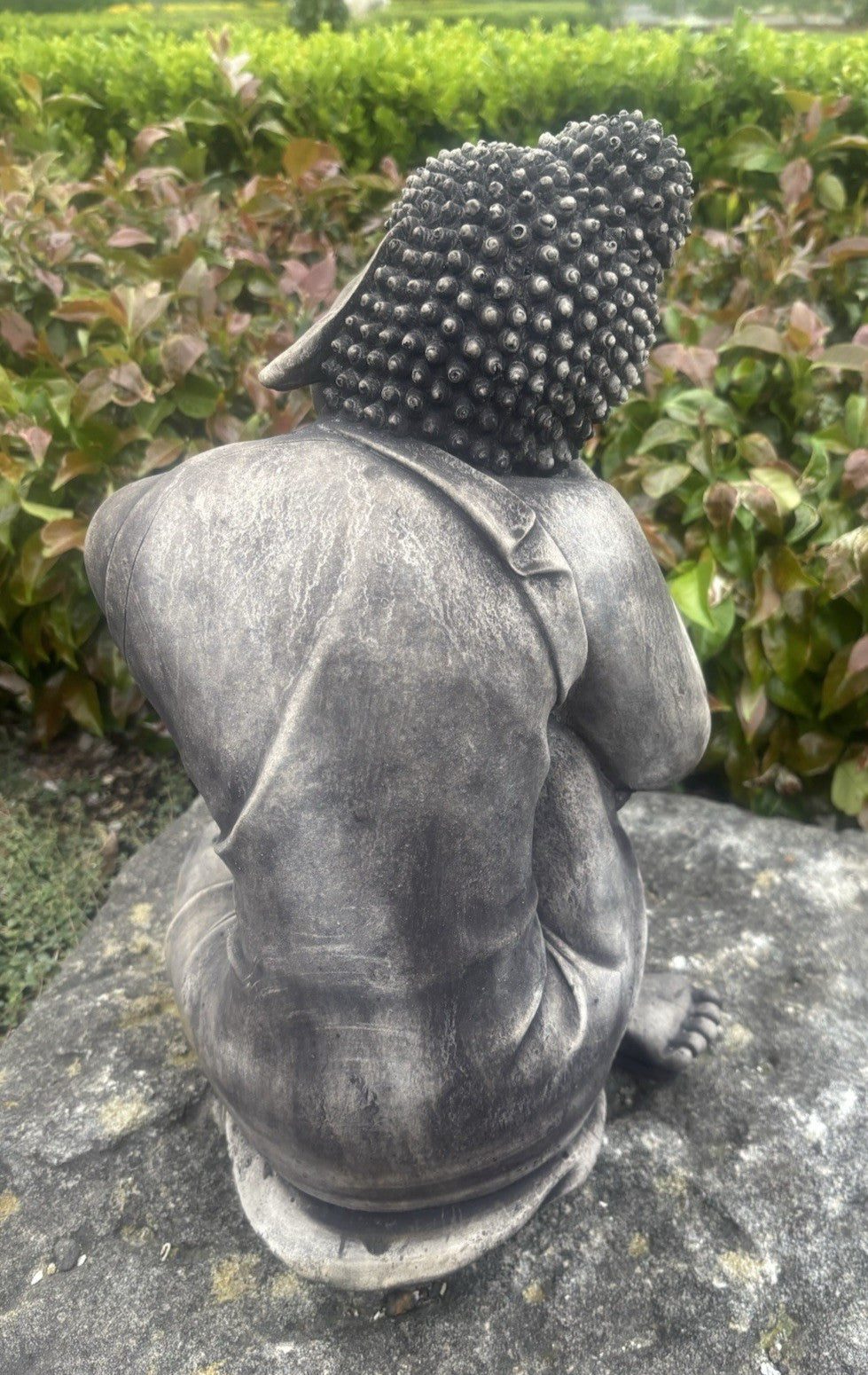 22nice4me Garden Statues concrete sleeping Buddha statue with a dark weathered finish seen from the back