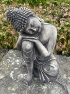 22nice4me Garden Statues concrete sleeping Buddha ornament with a dark weathered finish in a garden setting