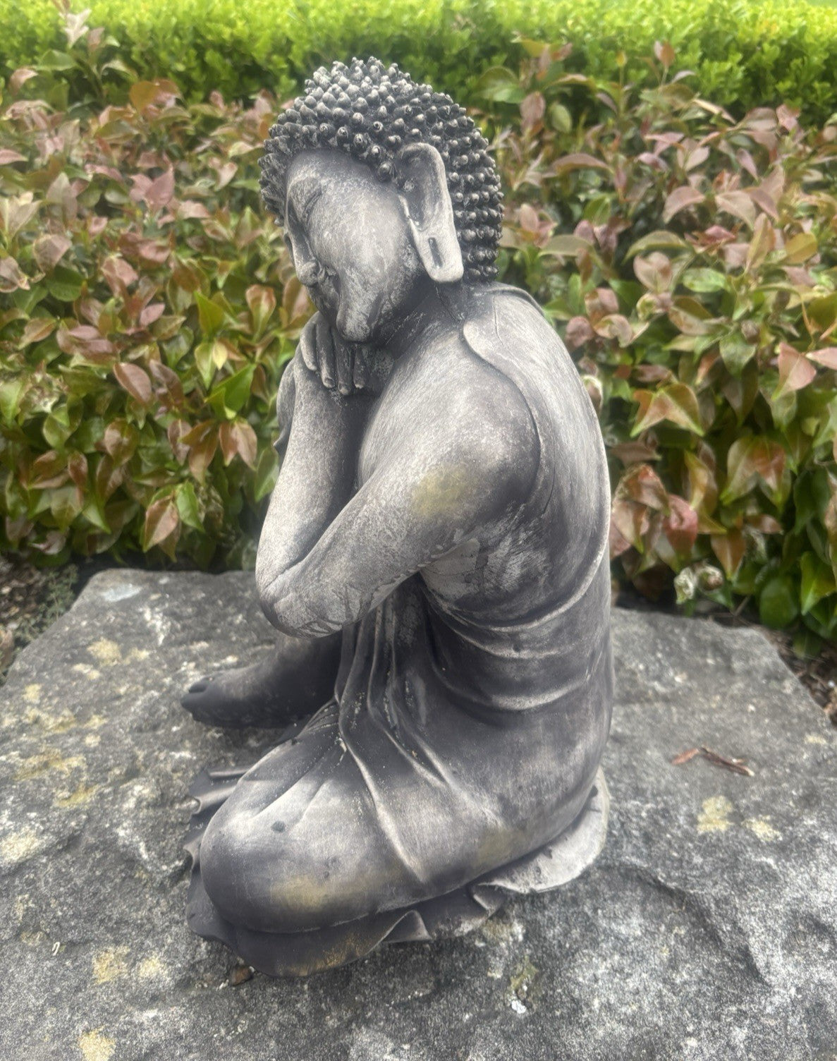 22nice4me Garden Statues concrete sleeping Buddha ornament with a dark weathered finish in a zen garden setting