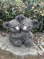 22nice4me Garden Statues grey concrete koala cuddling garden ornament with detailed fur texture in a garden setting
