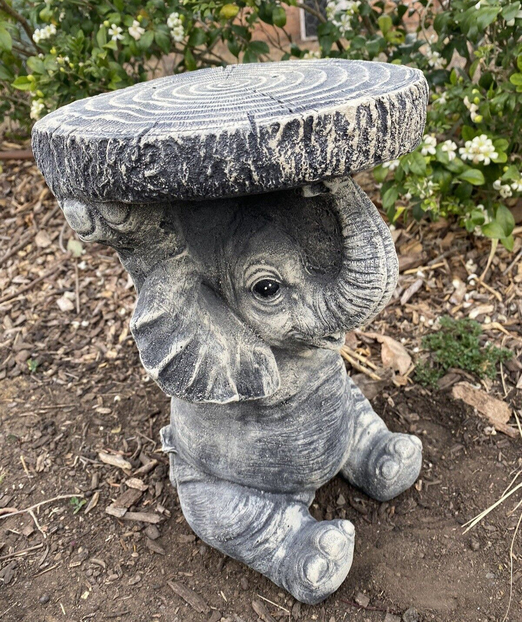22nice4me Garden Statues hand-painted concrete elephant pot plant stand with a tree stump top in a garden setting