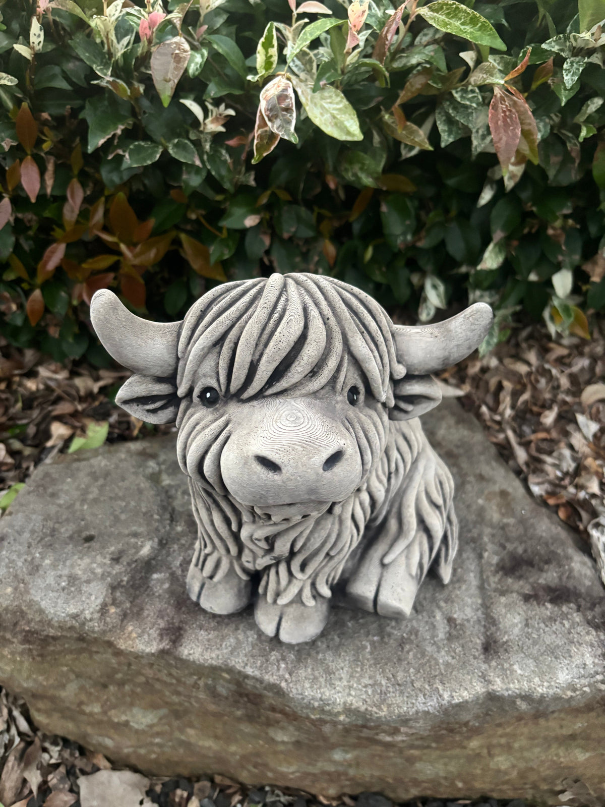 22nice4me Garden Statues rustic concrete Highland cow figurine with shaggy coat detail sitting on a garden rock.