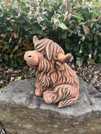 22nice4me Garden Statues rustic concrete Highland cow figurine with shaggy texture sitting on a stone in a garden