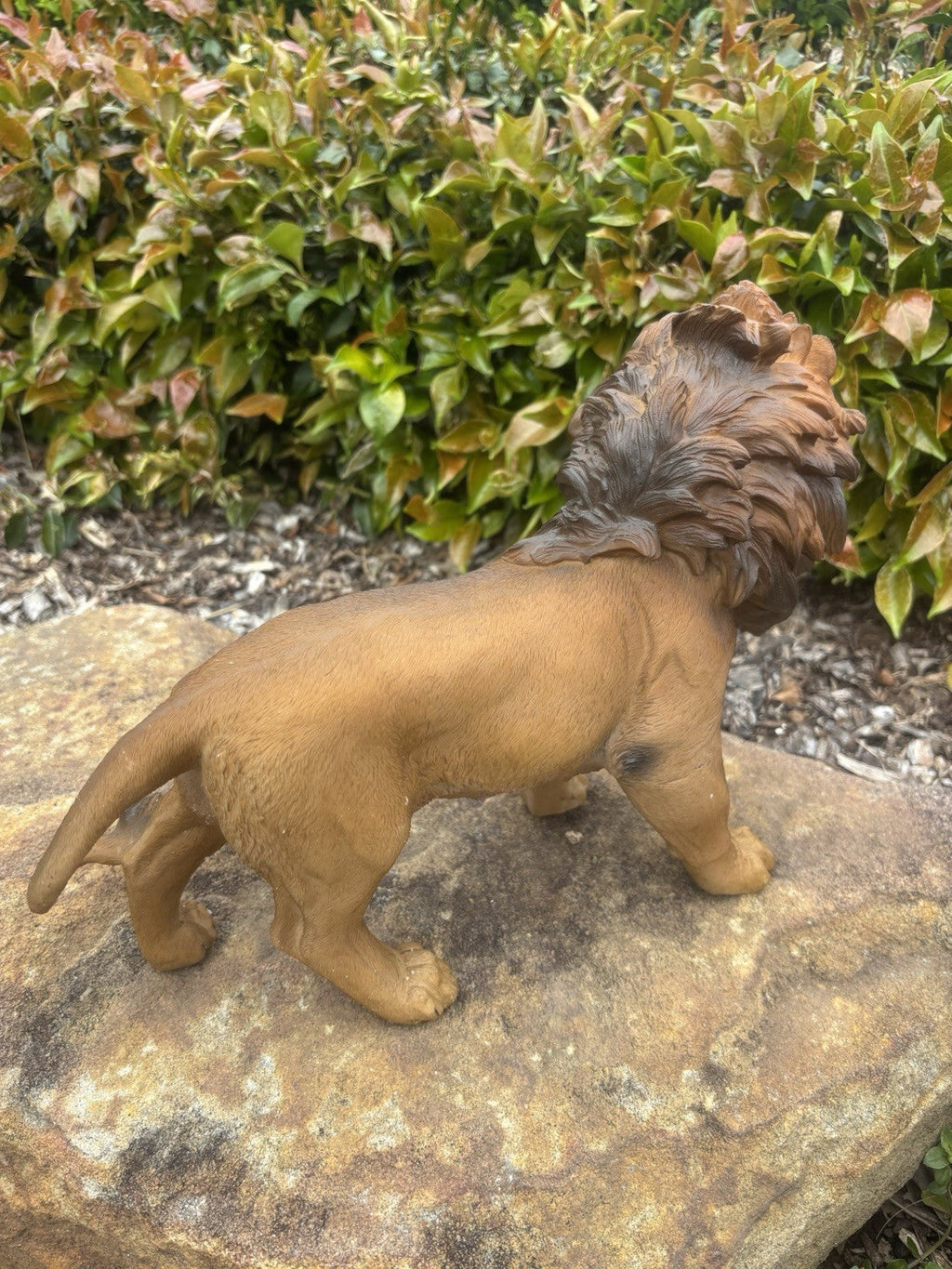 22nice4me Garden Statues resin lion ornament with textured mane, standing on a rock in a garden setting.