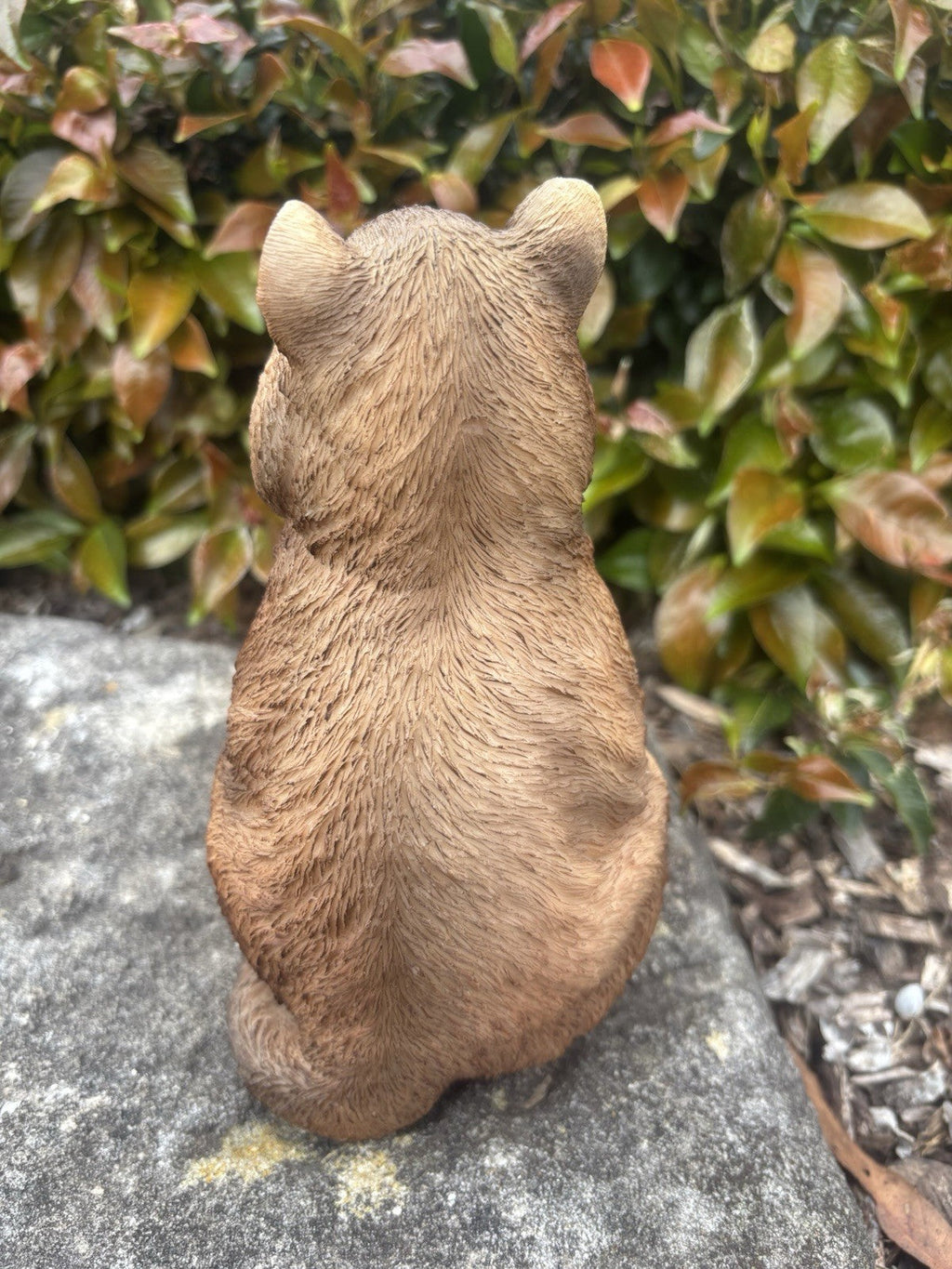 22nice4me Garden Statues resin quokka ornament, back view showing textured brown fur detail in a garden setting