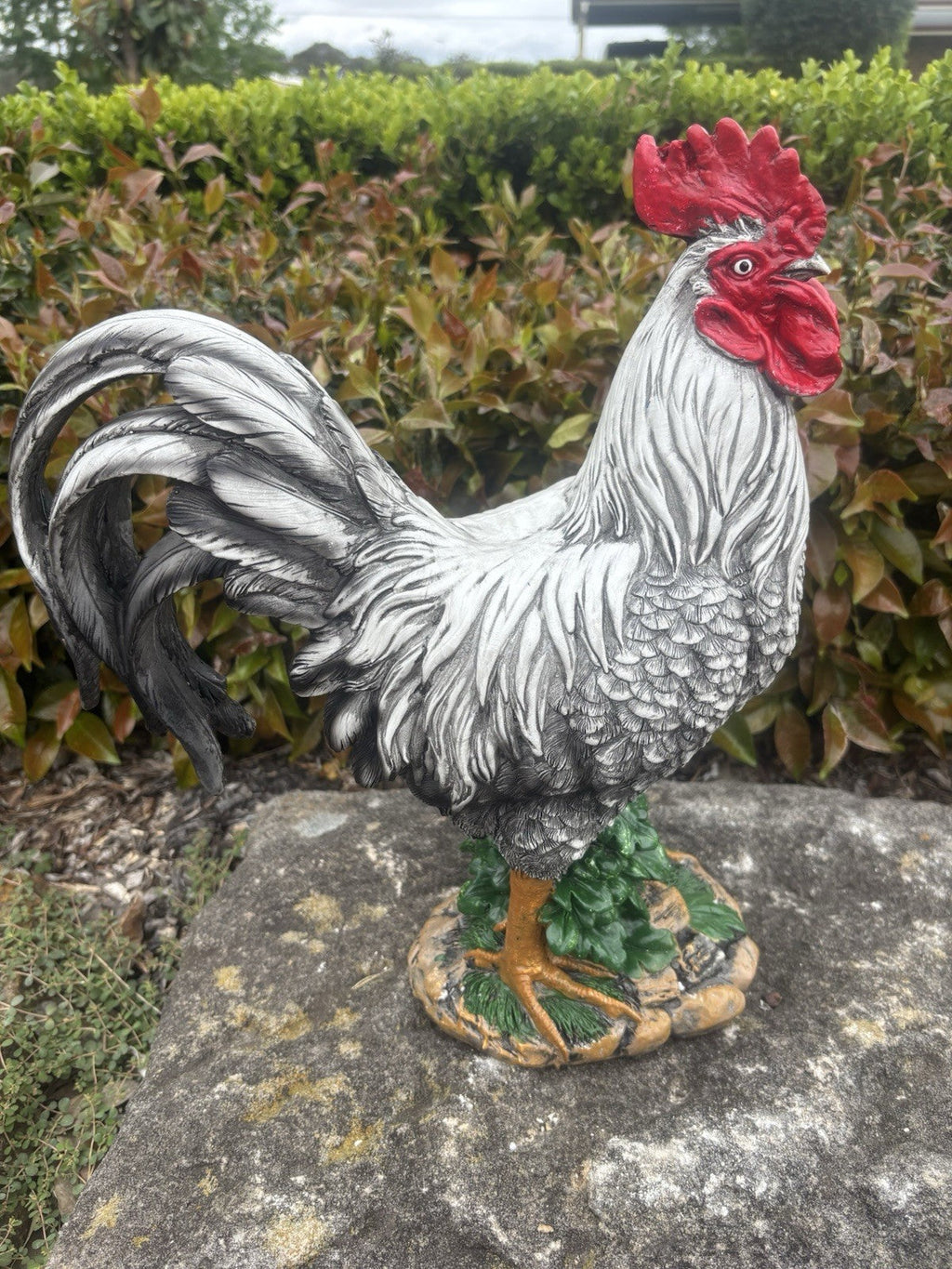 22nice4me Garden Statues resin rooster with white and silver feathers, red comb, and green foliage base in a garden.