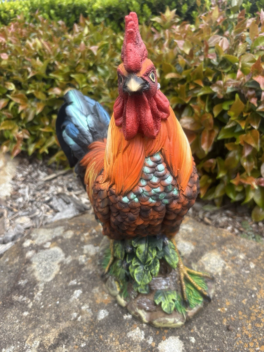 22nice4me Garden Statues resin rooster ornament with vibrant orange, red, and blue-black feathers on a leafy base.