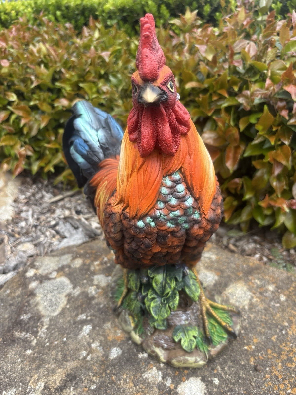 22nice4me Garden Statues resin rooster ornament with vibrant orange, red, and blue-black feathers on a leafy base.