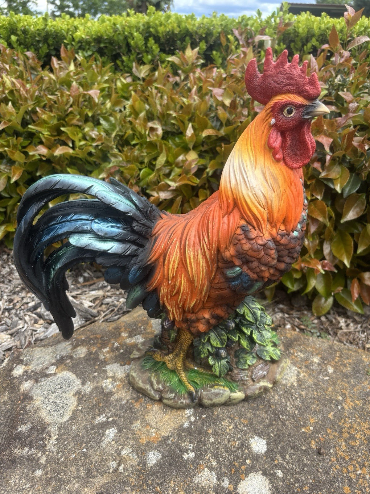 22nice4me Garden Statues resin rooster ornament with vibrant orange, red, and blue-black feathers on a stone base.