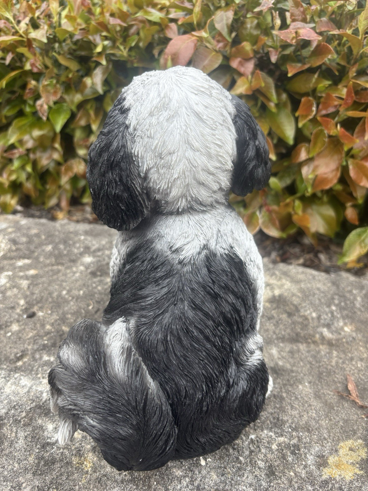 22nice4me Garden Statues resin Shih Tzu dog ornament in black and white, viewed from the back in a garden setting.