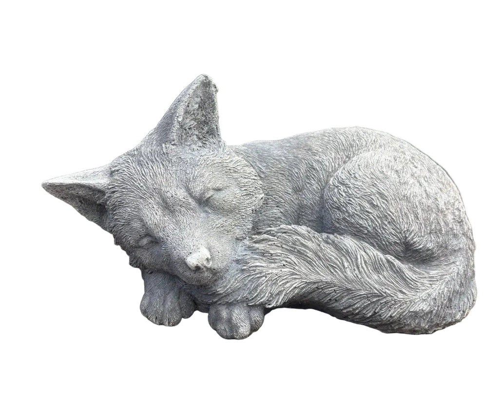 sleeping fox concrete garden statue displayed in a landscaped Australian garden 