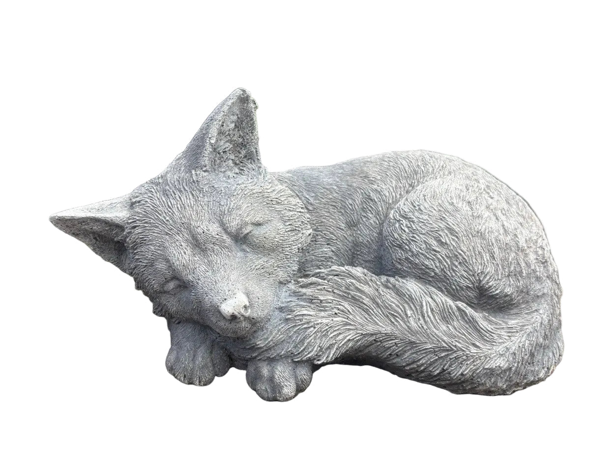 sleeping fox concrete garden statue displayed in a landscaped Australian garden 