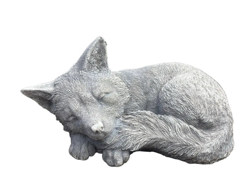 sleeping fox concrete garden statue displayed in a landscaped Australian garden 