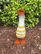 22nice4me Garden Statues metal duck ornament with yellow and white stripes standing on mulch in a garden