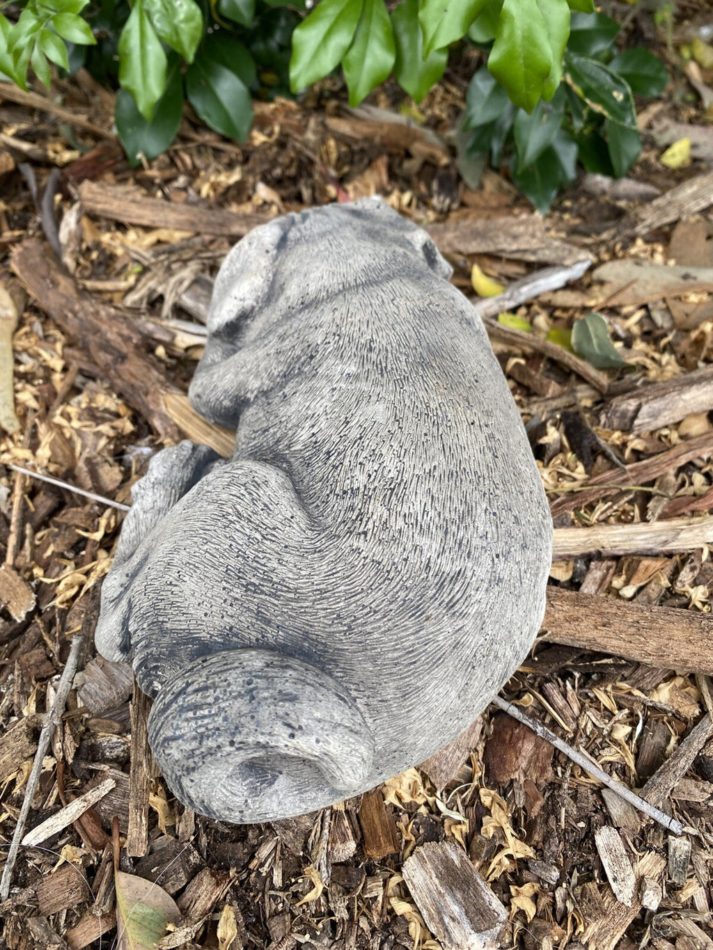 Back view concrete laying Pug garden statue outdoor cement dog ornament