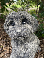 Close up detail of concrete maltese garden statue textured cement finish