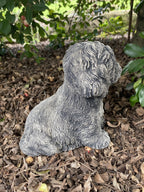Side view of concrete maltese garden statue outdoor dog ornament