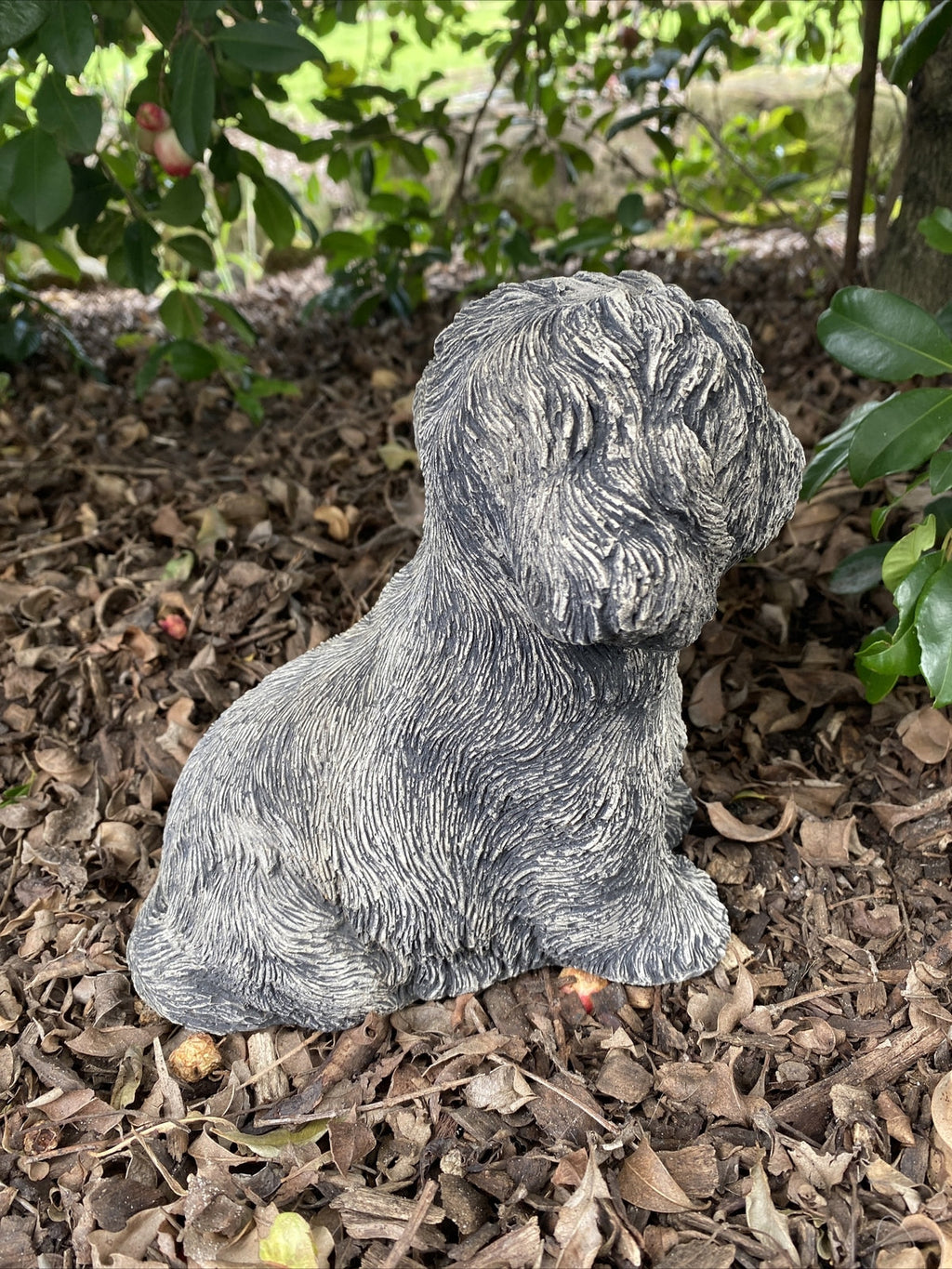 Side view of concrete maltese garden statue outdoor dog ornament