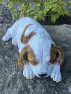 resin Cavalier King Charles Spaniel ornament in a sleeping pose on a stone surface