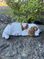  resin Cavalier King Charles Spaniel ornament in a realistic laying pose on a stone surface